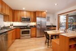 Fully equipped kitchen with hardwood floors and stainless appliances